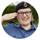 Teenage girl Sea Cadet smiling and saluting